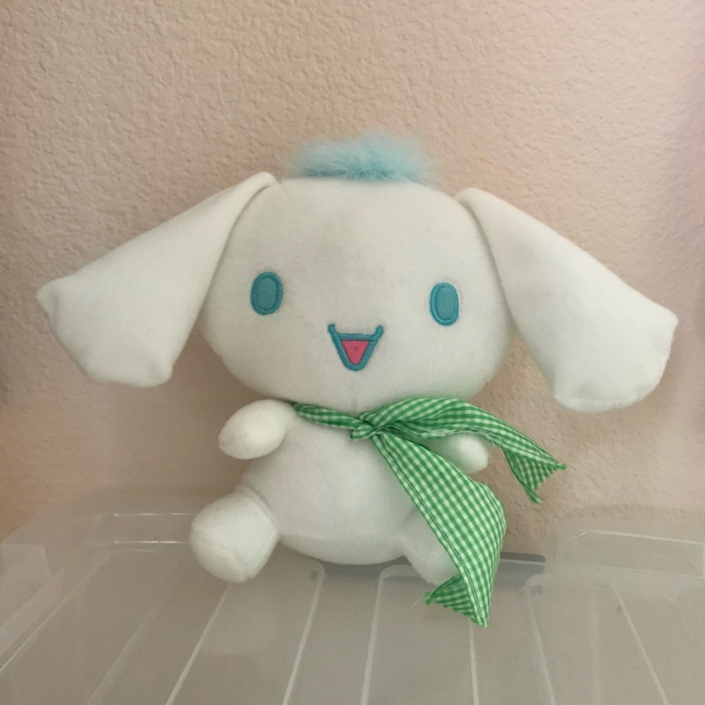 Medium-sized Cinnamoroll plushie with blue hair detail and green ribbon
